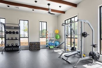 Yoga room with free weights, cable system, and kettlebells.